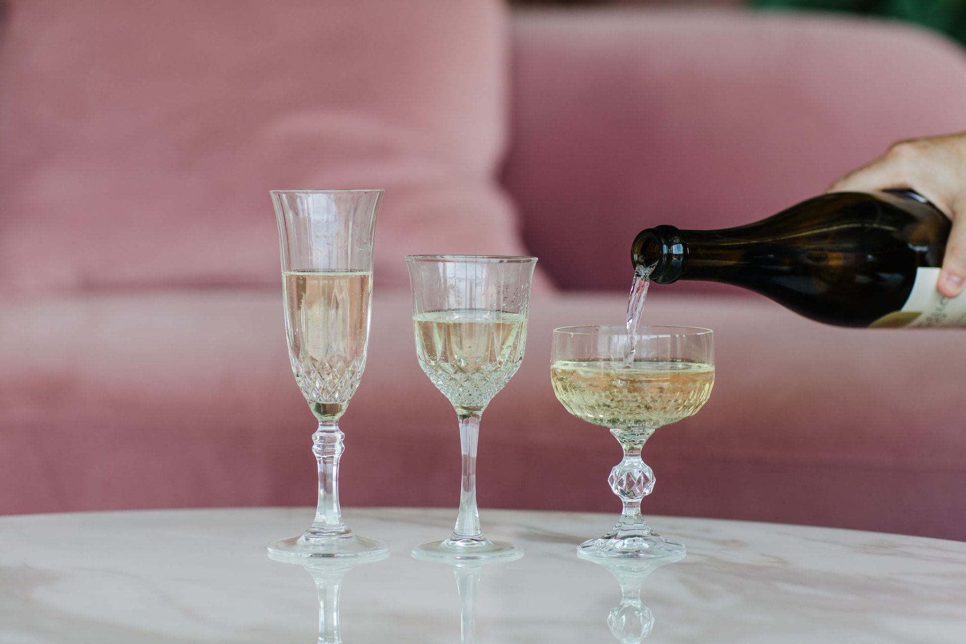 Sparkling wine being poured into elegant crystal glasses
